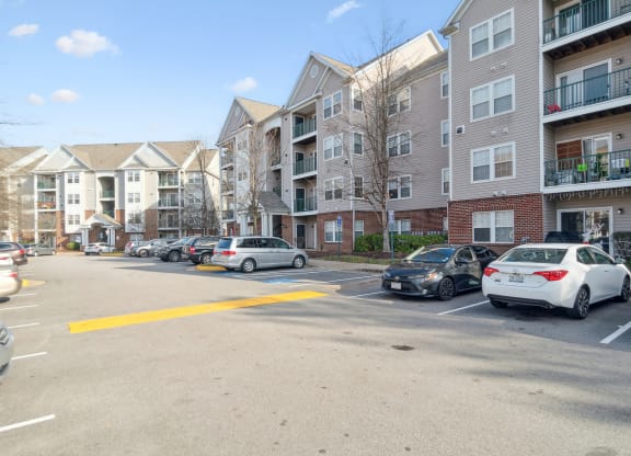 an empty parking lot in front of an apartment building at The Fields at Lorton Station, Virginia, 22079
