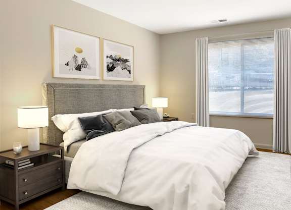 A bedroom with a large bed, two nightstands, and a window with curtains.