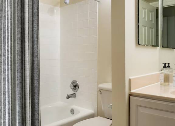 A bathroom with a white tub and sink.
