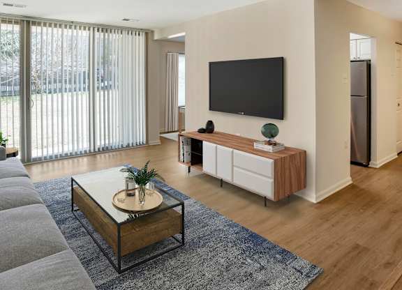 A modern living room with a flat screen TV mounted on the wall.