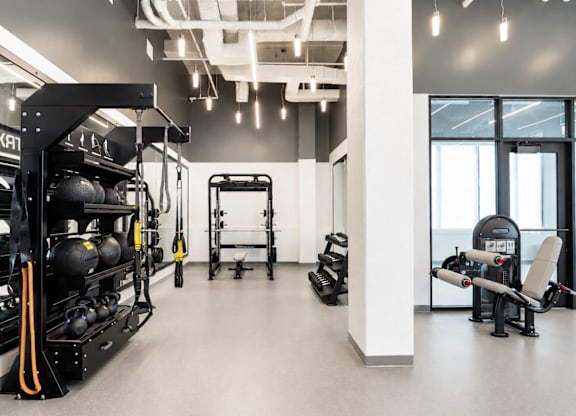 A gym with a variety of equipment including weights and machines.
