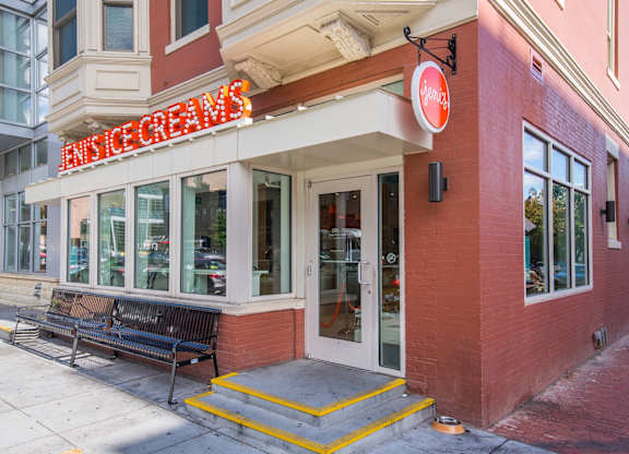 A bench is outside of a building with a sign that says