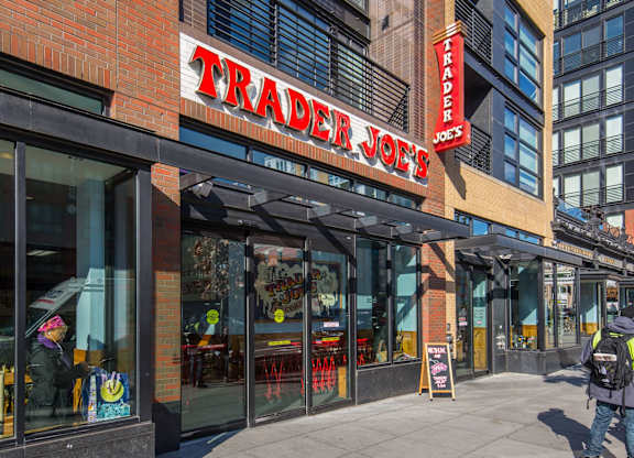 A Trader Joe's storefront with a person walking by.
