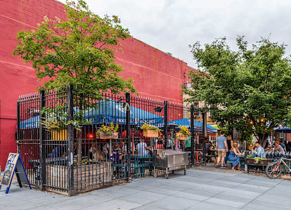 A red building with a tree in front of it.