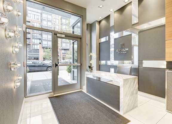 A modern front desk with a glass door leading to a balcony.