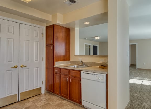 a kitchen with a sink and a dishwasher and a door to the laundry room at North Market South Carroll, Frederick, MD