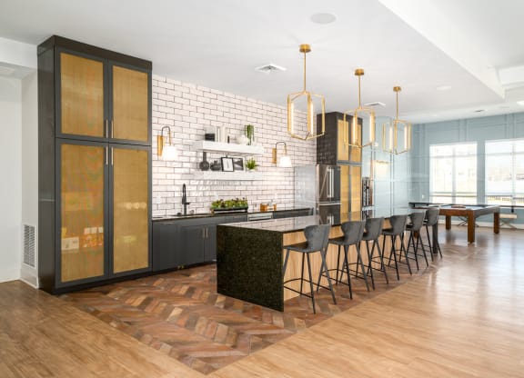 a large kitchen with an island and chairs in front of a dining room at Fairmont at South Lake, Bowie, MD