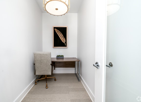 a home office with a desk and chair in a room with a door at Fairmont at South Lake, Bowie, MD, 20716