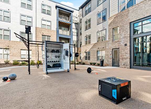 Outdoor fitness center with free weights at Preston Ridge Apartments in Cary, NC.
