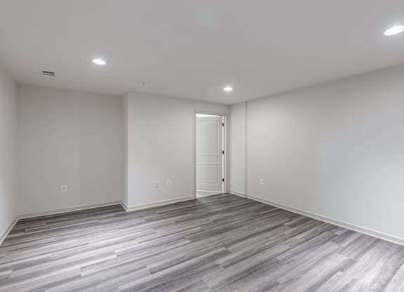 A room with a wooden floor and a white door at Garfield Park, Arlington, 22201