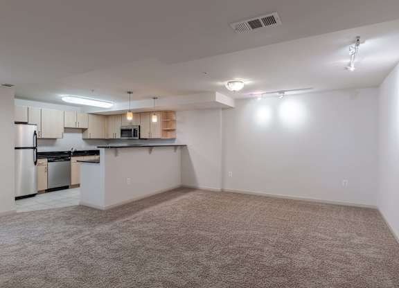 A spacious kitchen with white cabinets and stainless steel appliances at Garfield Park, Arlington, 22201