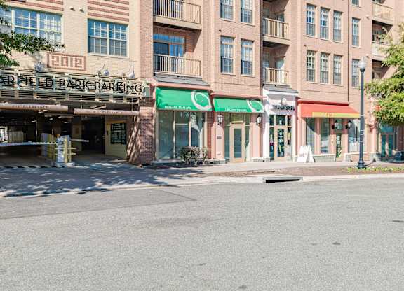 A parking garage is located in front of a building with a green awning at Garfield Park, Arlington, 22201