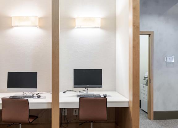 Two desks with computers and chairs in a room at Garfield Park, Arlington, 22201