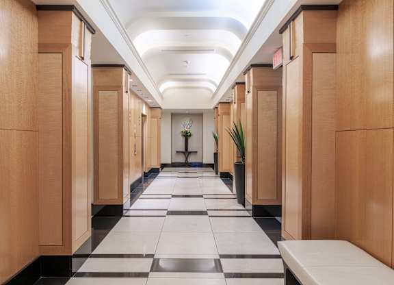 A long hallway with wooden doors and a checkered floor at Garfield Park, Arlington, 22201