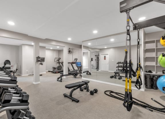 a gym with weights and cardio equipment in a room with white walls  at Brampton Moors, North Carolina