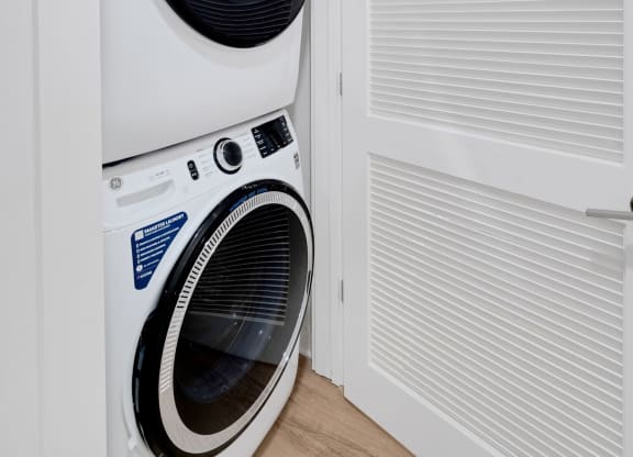 a washing machine and dryer in a small laundry room at Hawkins Press, Charlotte, North Carolina