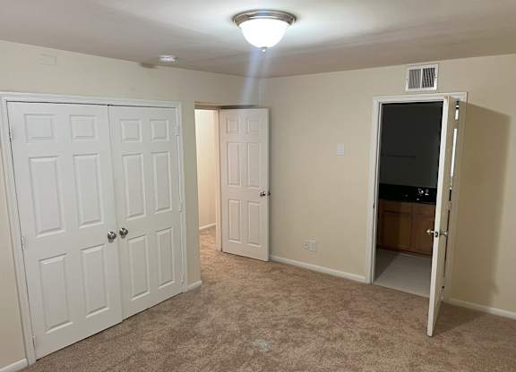 A room with a white door, a white closet door, and a white cabinet door at Shenandoah Station Apartments, Triangle, Virginia