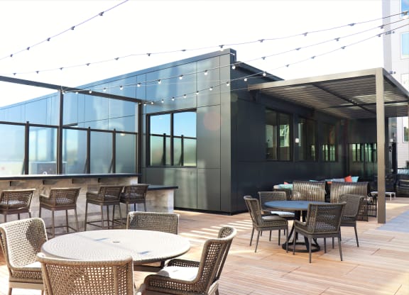 an outdoor patio with tables and chairs and a bar at Vyne One Loudoun, Ashburn, VA, 20147