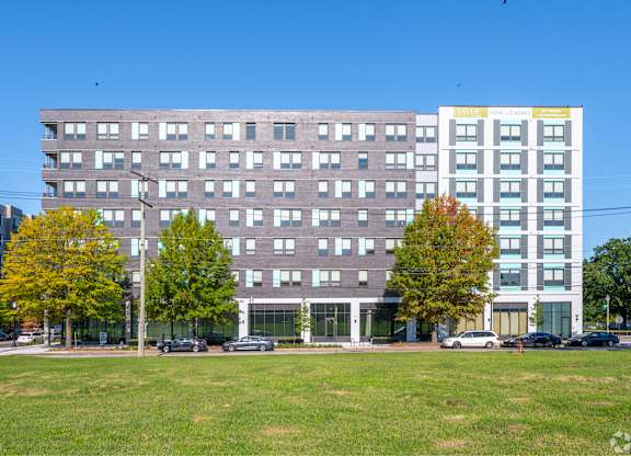 A large building with a grassy area in front of it.