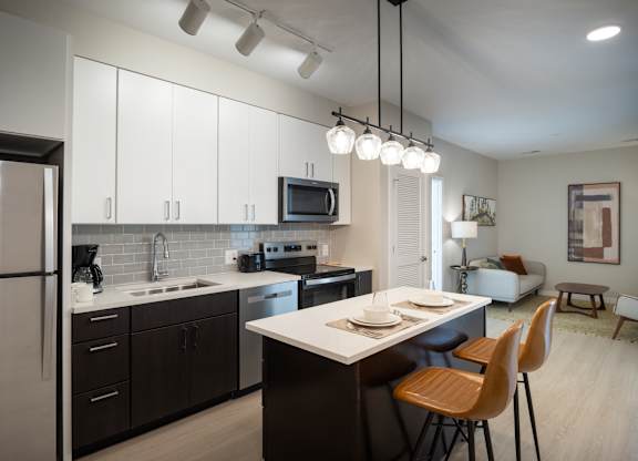 A modern kitchen with a dining table and chairs.