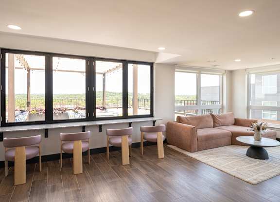 A living room with a couch, chairs, and a table.