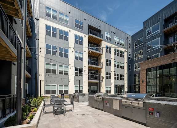 A modern building with a patio and outdoor furniture at The Sully Apartments, Virginia