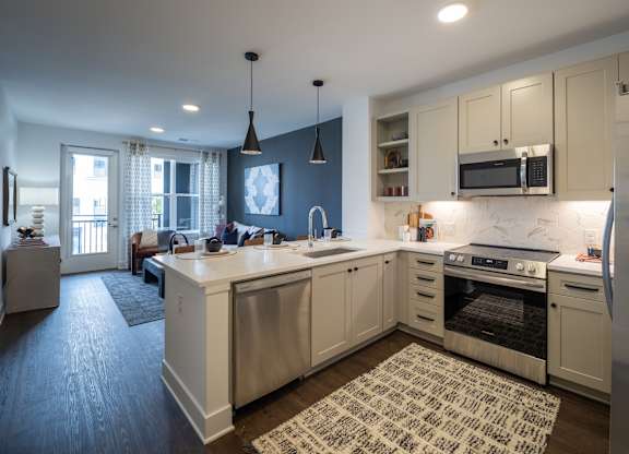 A kitchen with a large island and a refrigerator at The Sully Apartments, Virginia, 20151