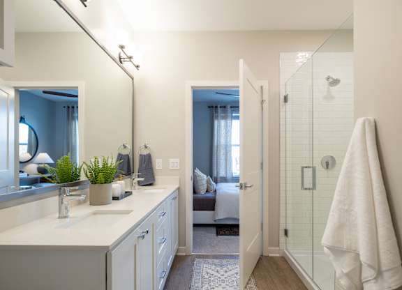 A bathroom with a white counter and a mirror.at The William, Chantilly, VA