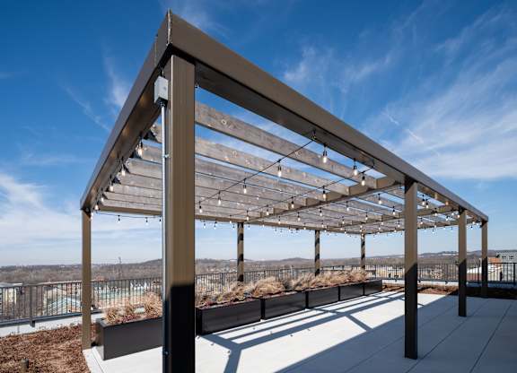 A modern pergola with wooden slats and metal frame.
