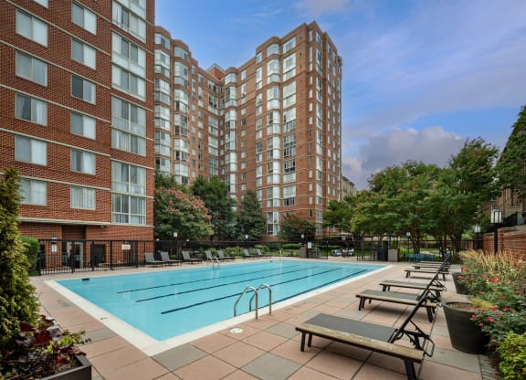 a swimming pool in front of an apartment building