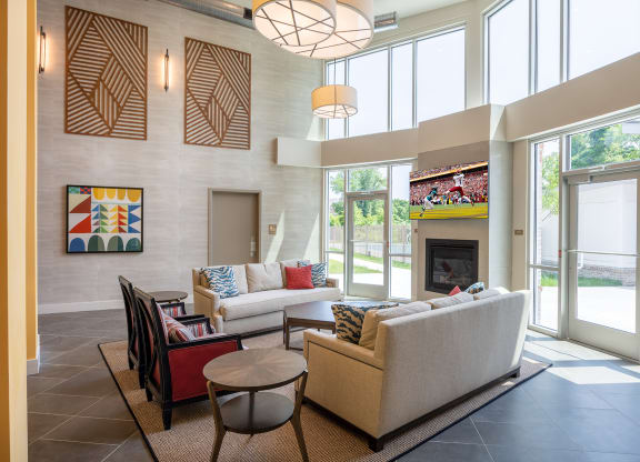 a living room filled with furniture and a large window  at Woodmore Grand, Bowie, 20721