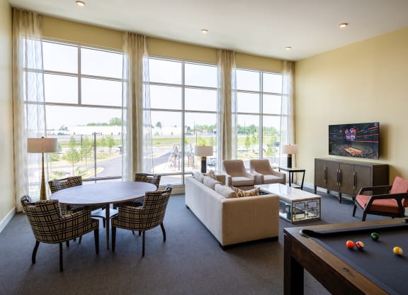 a living room with a pool table and a flat screen tv  at Woodmore Grand, Maryland, 20721