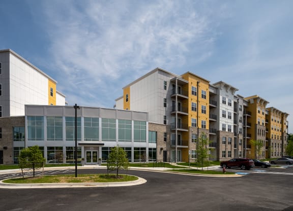 an exterior view of a large building with a parking lot in front of it  at Woodmore Grand, Bowie, 20721
