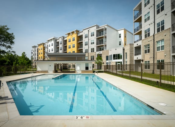 a swimming pool in front of an apartment building  at Woodmore Grand, Maryland, 20721