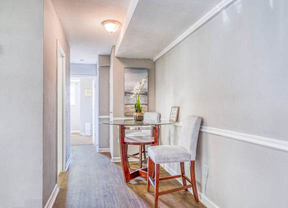 A dining room with a table and chairs at Huntwood Courts Apartments, Washington, DC