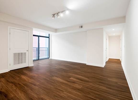 A room with wooden floors and white walls.