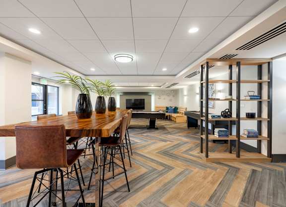 A conference room with a long table and chairs.