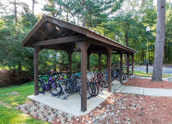 A wooden pavilion with bicycles parked in front.at Crestline Cary, Cary, NC