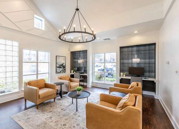A living room with a large window and a chandelier.at Crestline Cary, Cary, NC