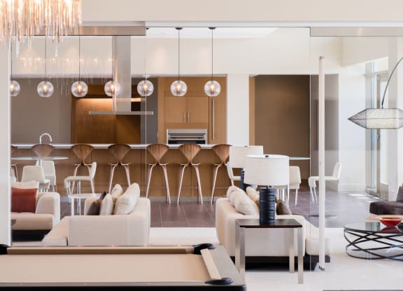 a living room filled with furniture and a pool table at The Acadia at Metropolitan Park, Arlington, Virginia