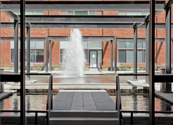 a large fountain in the middle of a building at Tindeco Wharf, Baltimore, MD