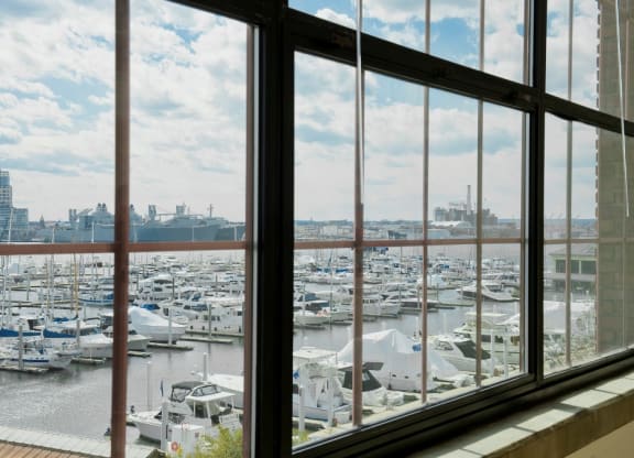 a window view of a marina filled with boats at Tindeco Wharf, Baltimore, MD 21224
