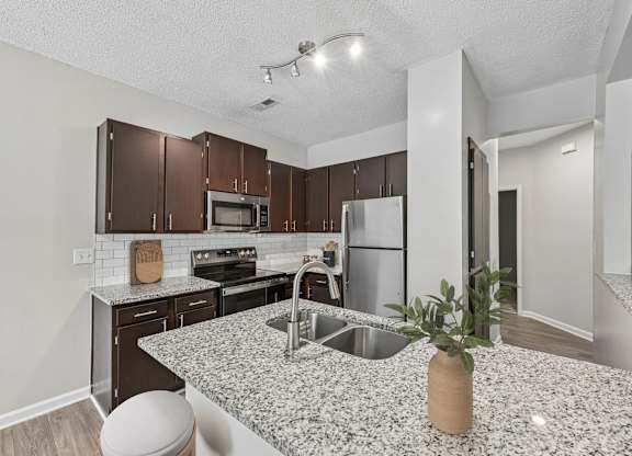 A kitchen with a granite countertop and a sink.