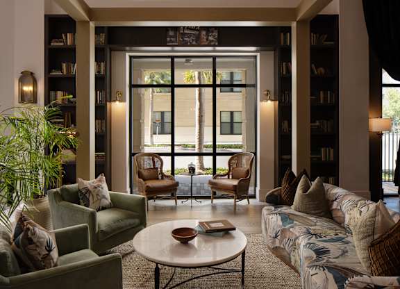 A living room with a couch, chairs, and a coffee table.
