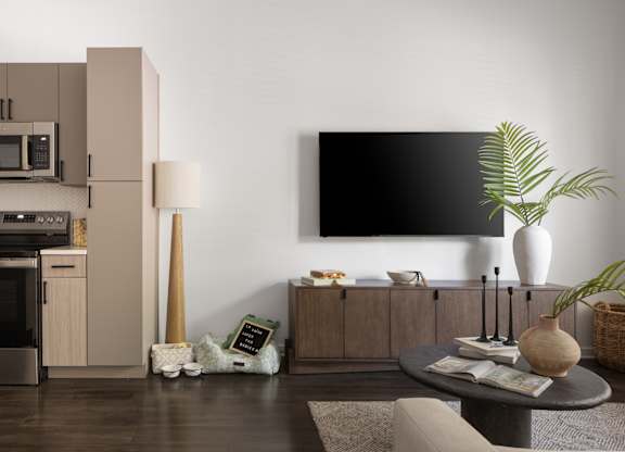A modern kitchen with a dark oven and a black fridge.
