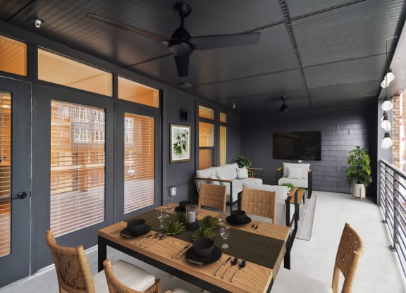 a living room with a wooden table and chairs and a television at Hawkins Press Apartments, Charlotte