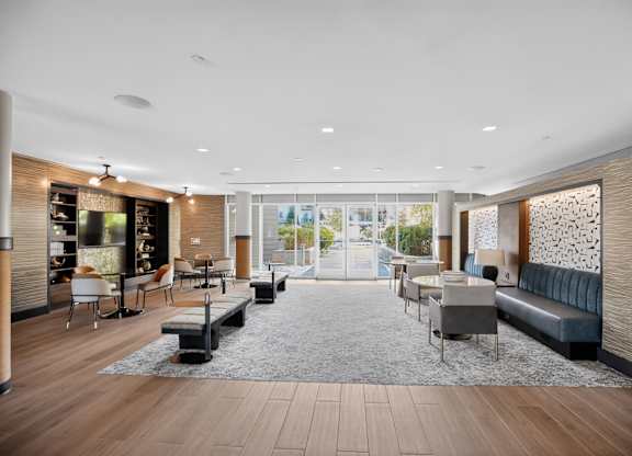 A modern living room with a large window and a view of the city.