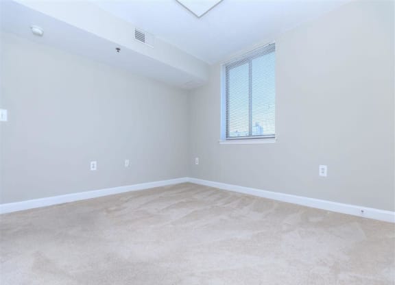 an empty bedroom with a window at The Gramax, Silver Spring