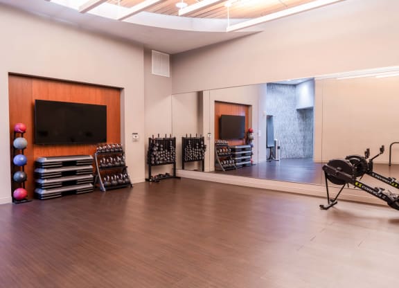 a large room with a drum set and a tv on the wall and a mirror at The Acadia at Metropolitan Park, Virginia