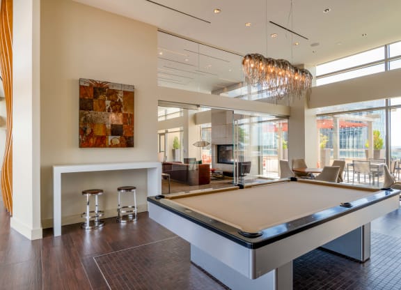 a game room with a pool table and a bar at The Acadia at Metropolitan Park, Virginia, 22202